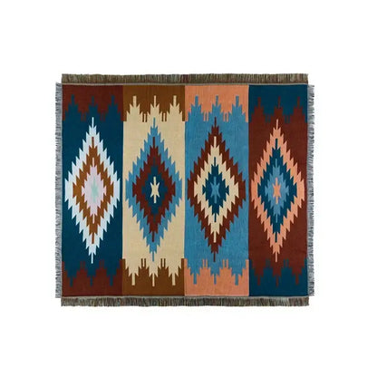 A rectangular decorbites bohemian nordic woven rug with bold teal orange geometric diamond patterns and fringed edges
