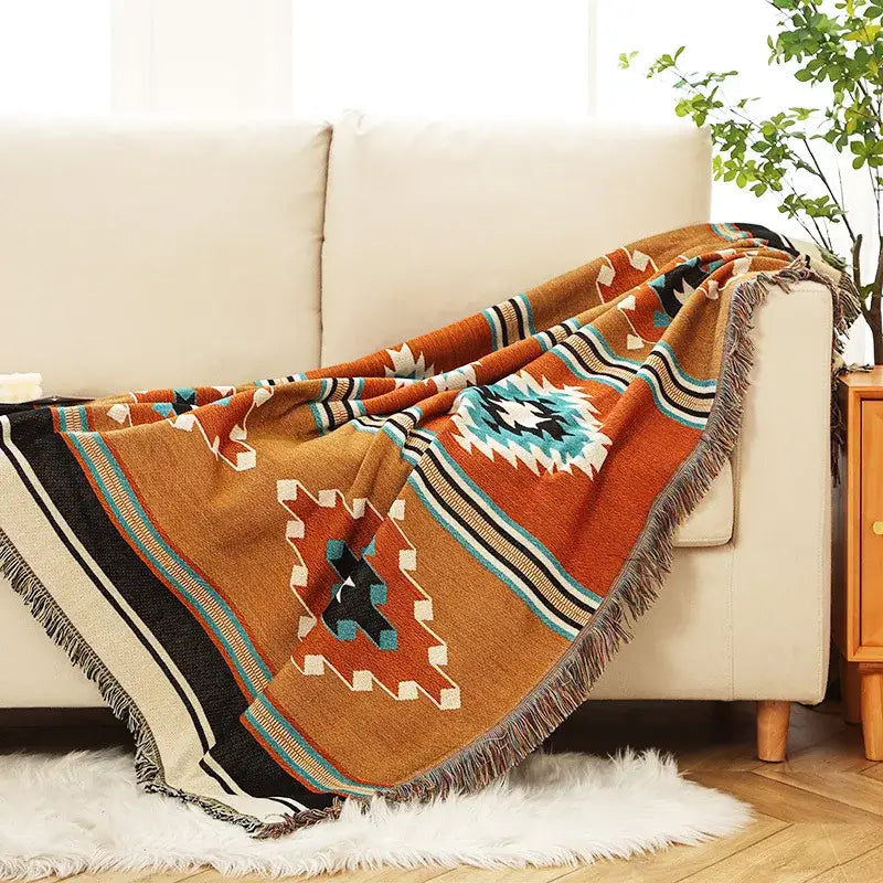 Bohemian orange geometric woven throw blanket with fringe detailing by decorbites for cozy bedroom decor