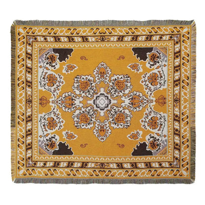 A decorbites bohemian outdoor blanket with mustard yellow base and intricate floral paisley pattern with fringed edges