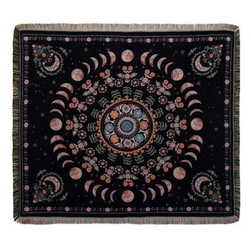 Black throw blanket with moon phase and floral patterns in pinks blues and golds with fringed edges from decorbites bohemian outdoor blanket collection