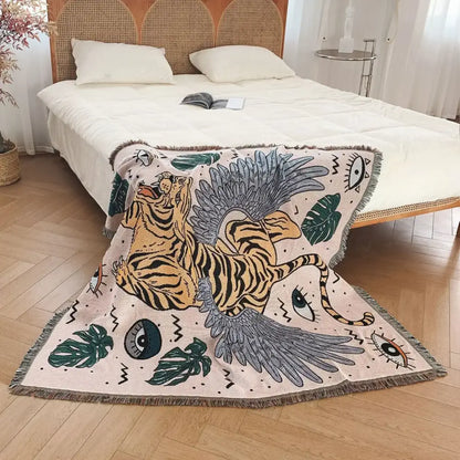 A cream bohemian outdoor blanket by decorbites featuring a vibrant winged tiger and tropical leaves in orange and gray tones