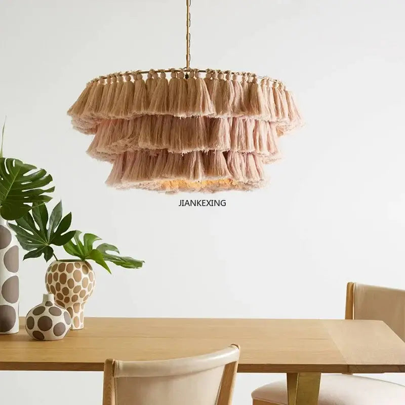 Beige tiered tassel pendant light with woven frame and hanging chain from decorbites bohemian vintage fela collection