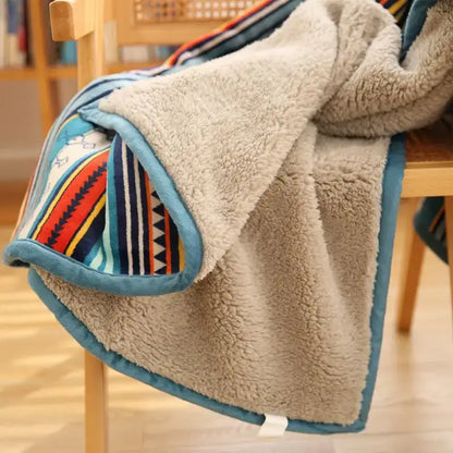 A cozy beige bohemian winter blanket with colorful stripes and teal trim made of sherpa fleece for living room use