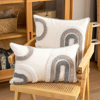 White rectangular cushion cover with textured gray and cream plush yarn arches for boho style home decoration decorbites