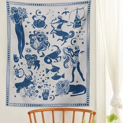A white wall hanging with blue zodiac signs and celestial motifs in a constellation tarot boho tapestry design