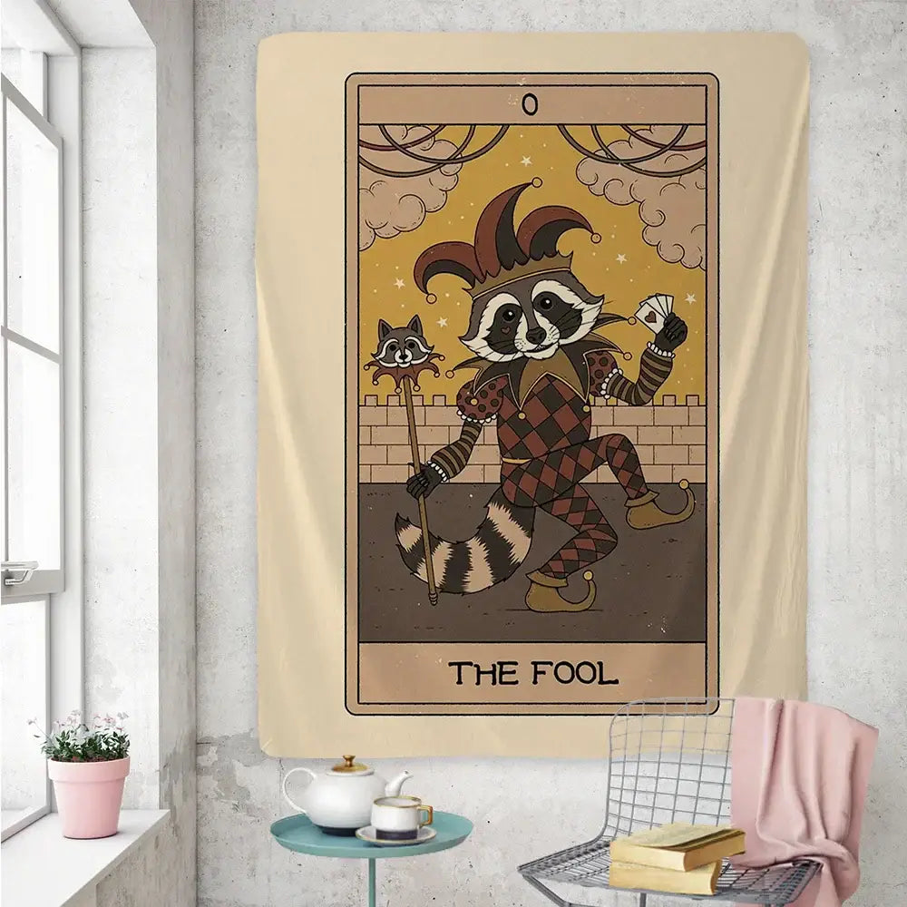 Beige tapestry wall art featuring a cute raccoon tarot card the fool dressed as a jester holding cards and staff