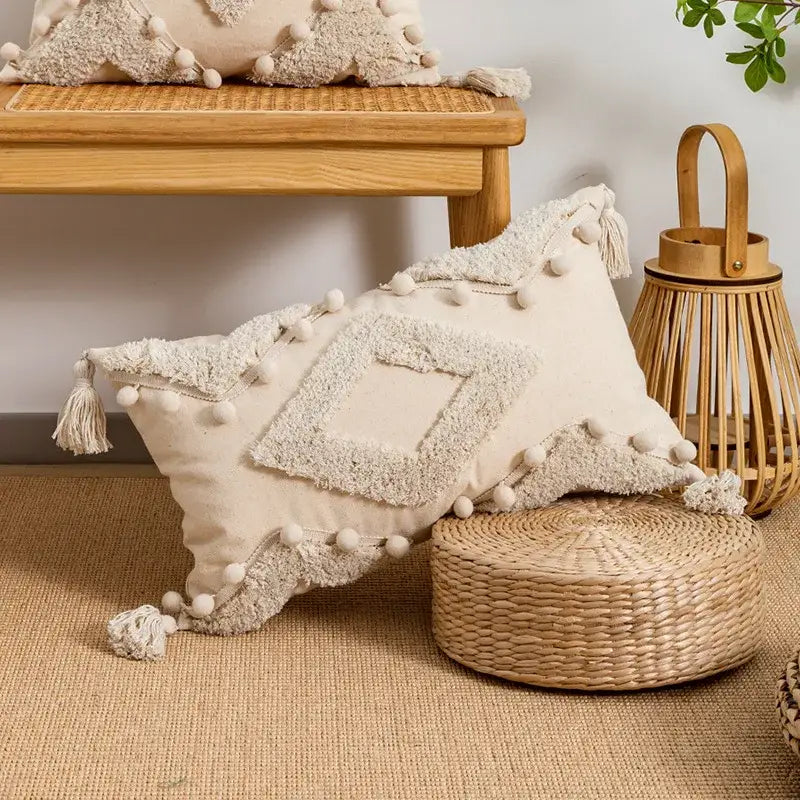 Beige boho style cushion cover featuring textured fabric with pom-poms and tassels for living room decorbites decor