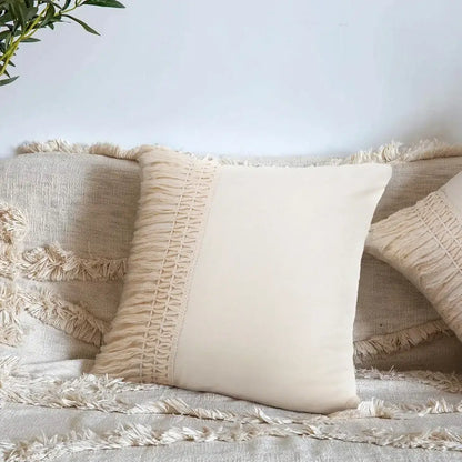 Cream-colored cushion cover with woven detailing and fringed border for decorbites beige boho style living room decor