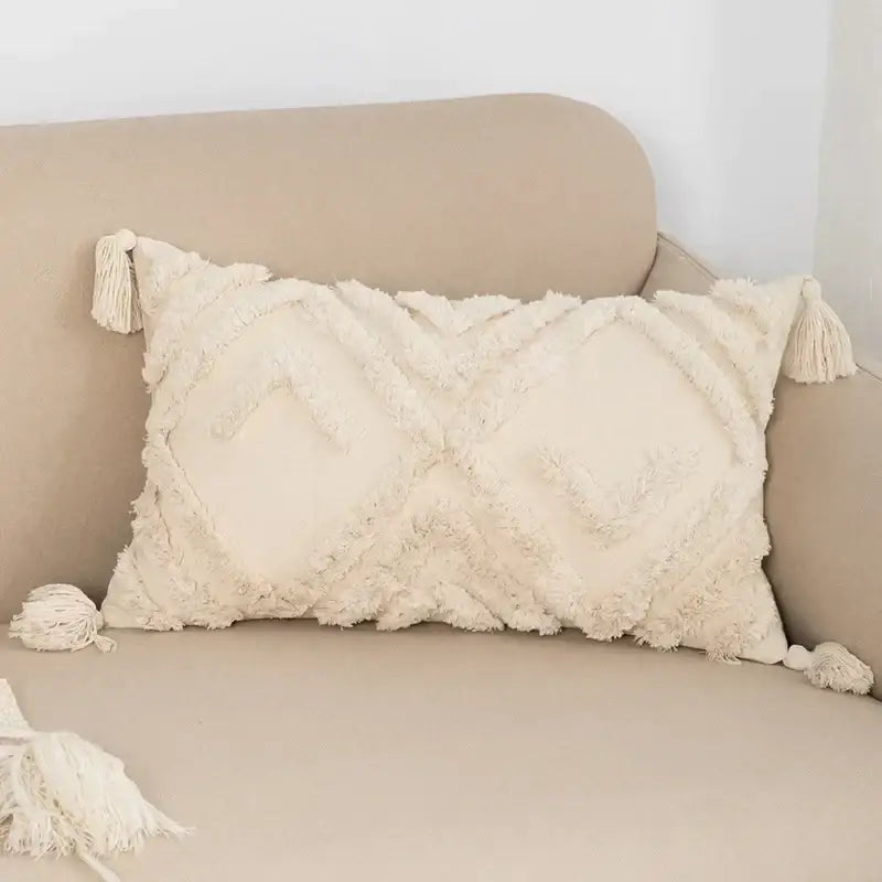 Cream-colored rectangular cushion cover boho beige style with textured fringed fabric and tassels for living room decorbites