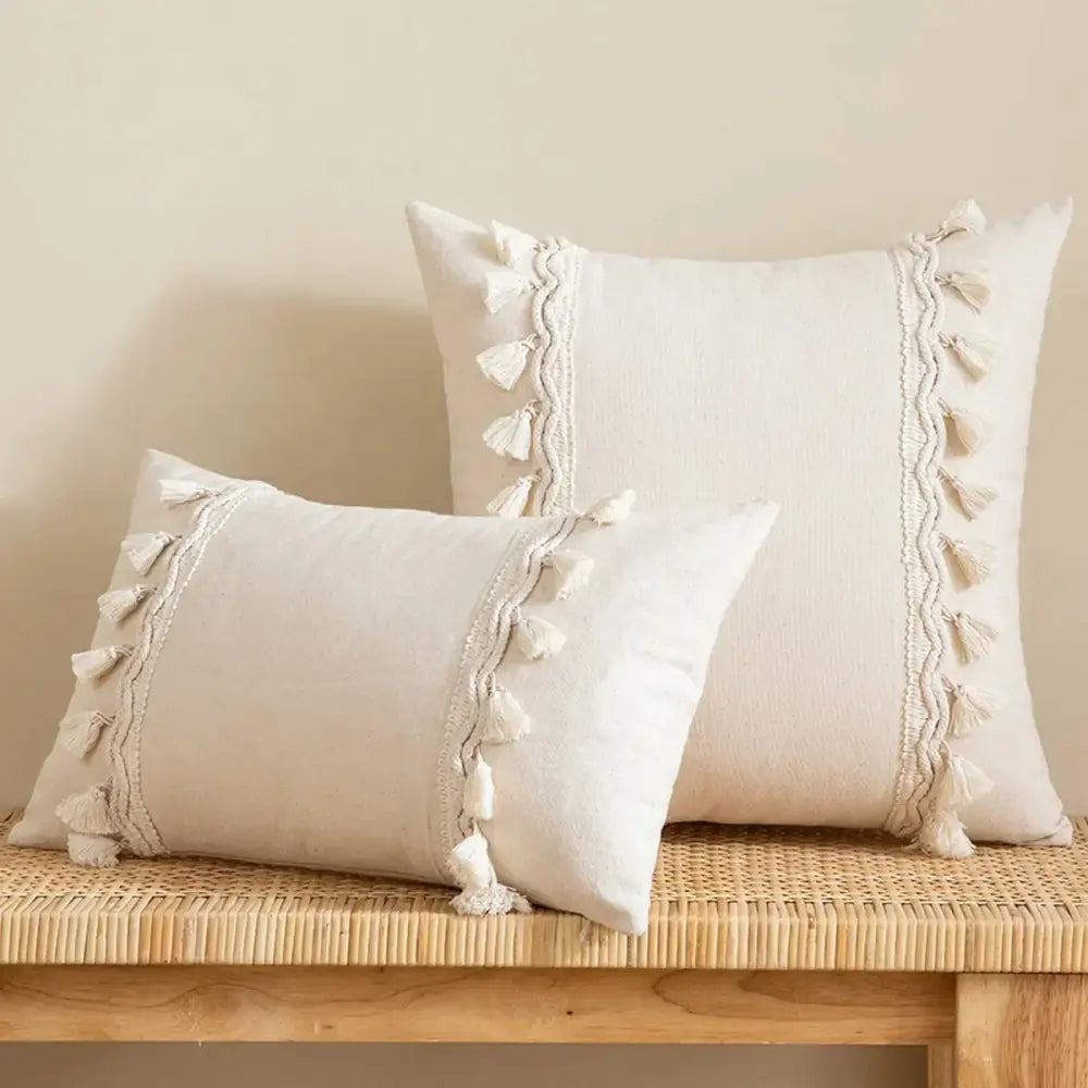 Cream-colored rectangular cushion cover with tufted fringed decorbites beige tufted fabric and tassel trim for living room decor