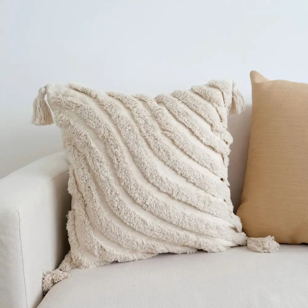 Cream-colored boho beige white pillow cases with textured fabric and woven tassels for living room decorbites boho beige decor
