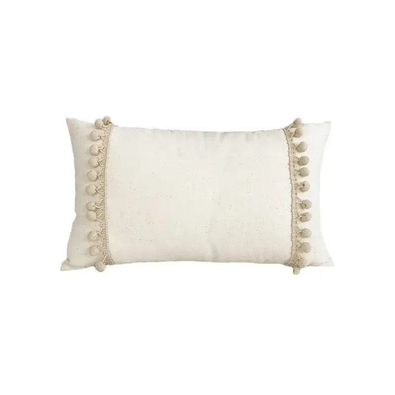 Cream-colored boho pillow cover with soft pom-poms made of linen cotton for living room decor pillow covers