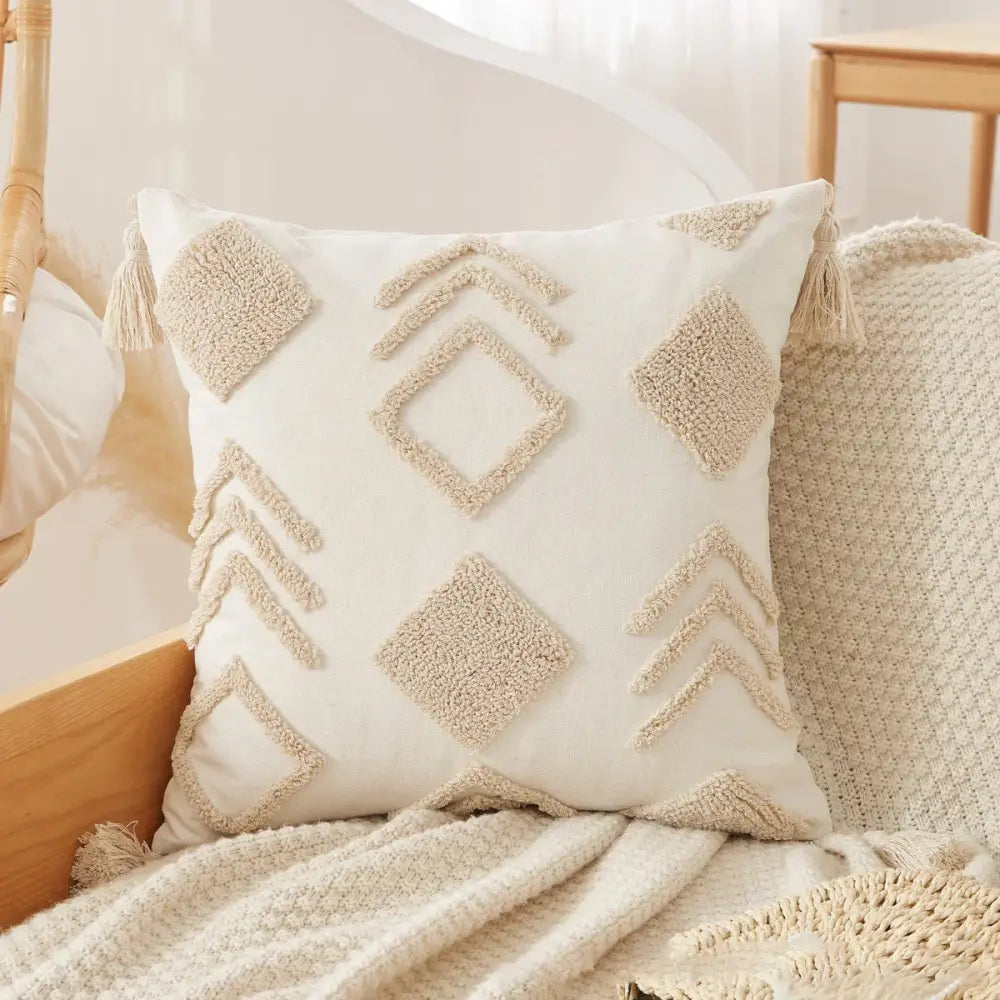 Cream-colored tufted tassel cushion cover with textured geometric patterns and tassels for living room decor
