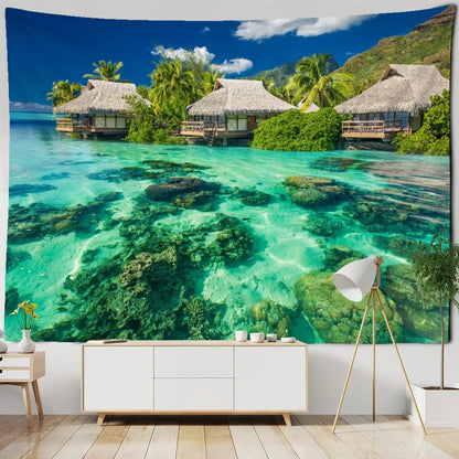 Bohobites coastal cave tapestry wall hanging featuring vibrant turquoise tropical beach scene with thatched huts