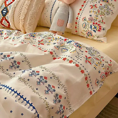 Cream-colored boho cotton printed duvet cover with intricate red blue and green floral embroidery from decorbites bedding set