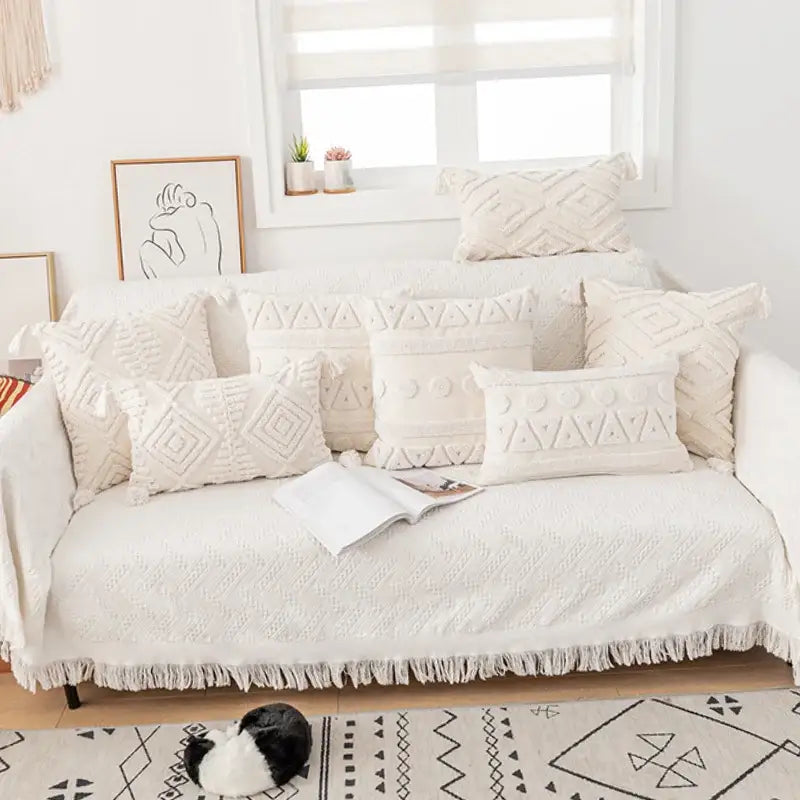 Cream-colored textured sofa cover with geometric embroidery and fringe detailing for decorbites cotton tassels cushion covers
