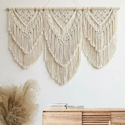 Cream-colored macrame wall hanging tapestry with intricate geometric patterns and long fringe for bedroom decor
