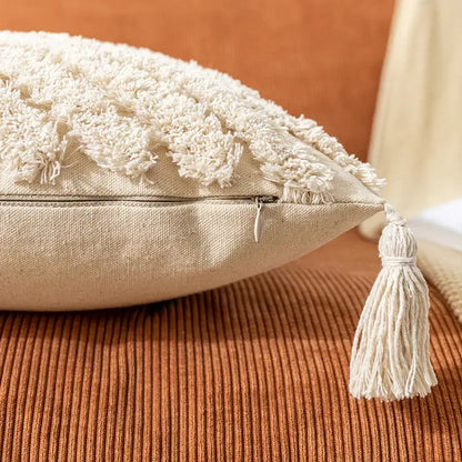 Cream-colored boho cotton pillow cover with textured fluffy tassel trim and matching fabric tassel zipper pull decorbites boho cotton tassel