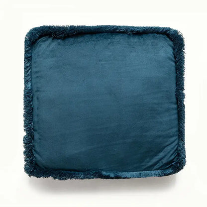 Deep teal velvet cushion with a fringed edge.