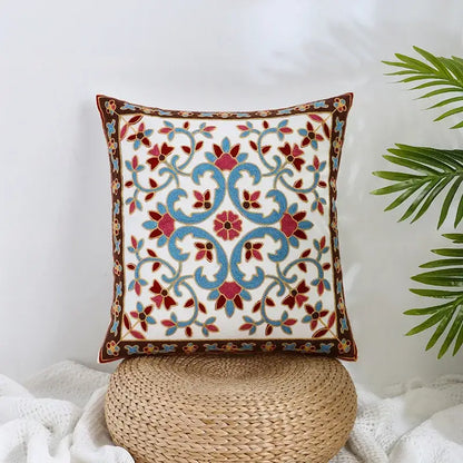 White cushion pillow cover with intricate blue and red floral embroidery on brown border decorbites boho farmhouse floral design