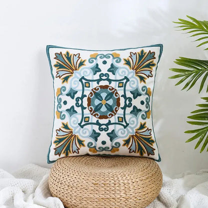 Boho farmhouse floral pillow covers featuring teal blue and gold embroidered patterns on a cream decorbites fabric