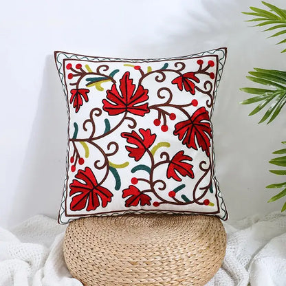 White square pillow cover with vibrant red green and brown embroidered leaves on cream decorbites boho farmhouse floral fabric