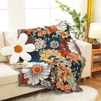 Cozy boho floral cotton blanket in navy blue with vibrant orange white yellow pattern and fringed edges for decorbites throw
