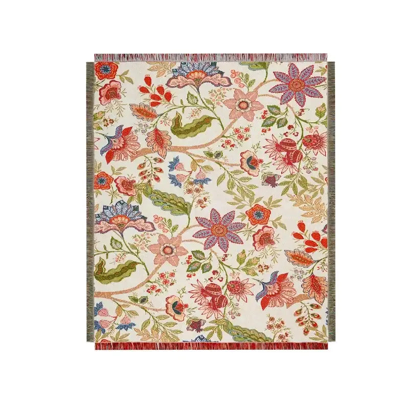 Cream-colored woven throw blanket with vibrant boho floral pattern in red pink purple and blue for floral sofa throw decorbites boho floral