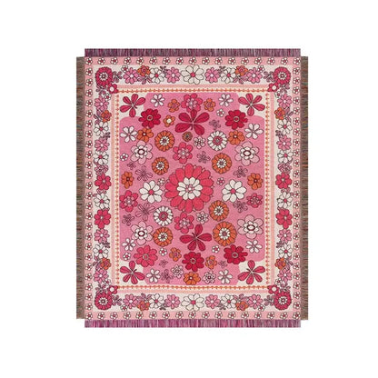 Vibrant pink woven boho floral sofa throw blanket with dense red white and orange pattern and decorative fringes decorbites boho floral