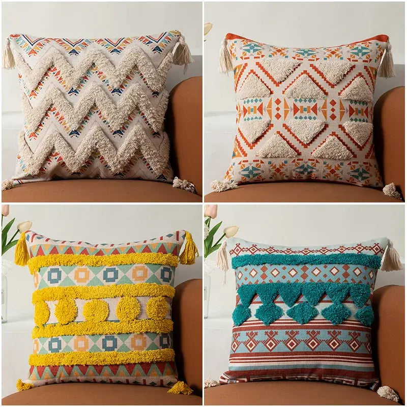 Four decorative throw pillows with colorful geometric patterns and textured tassels in various hues including cream, orange, yellow, and teal.