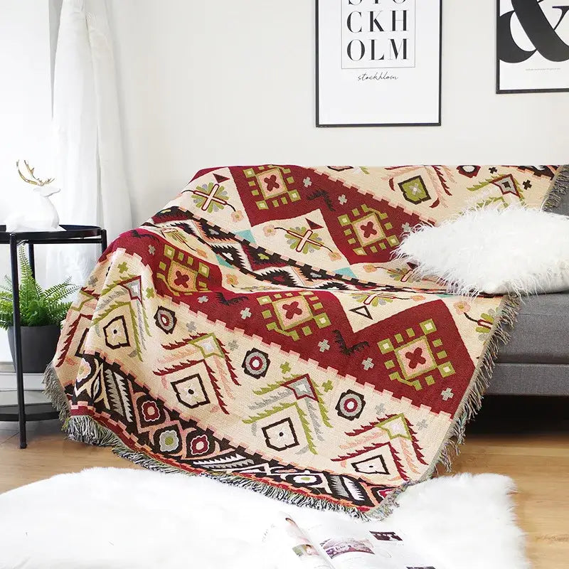 Cozy cream throw blanket with bold red green and black geometric pattern and fringed edges for decorbites geo ethnic style