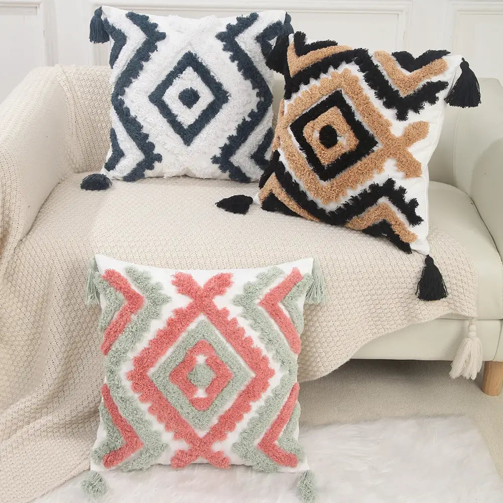 Three textured pillow covers with boho geometric chenille embroidered patterns in navy beige coral and sage green decorbites