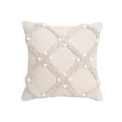 Beige cushion cover with textured frayed crosshatch and white pom-poms decorbites boho geometric tufted pillow