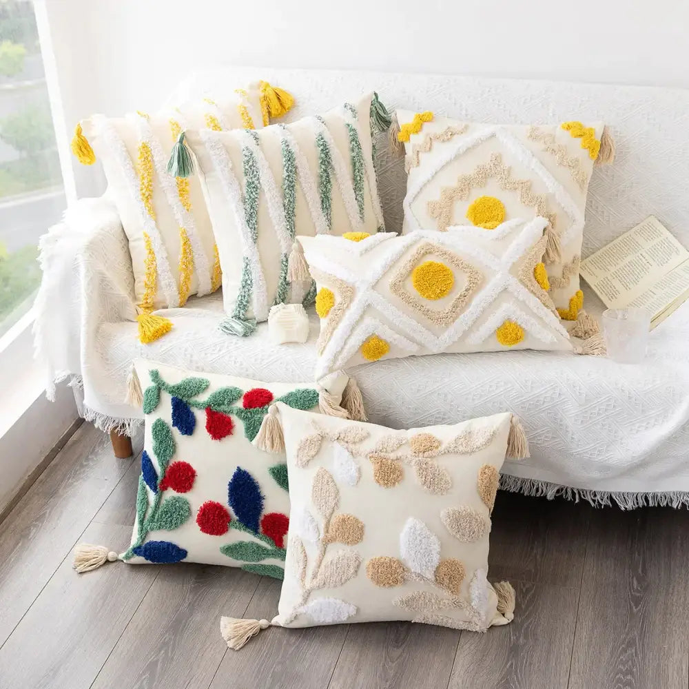 Cream-colored cushion cover with yellow green blue tufted embroidery and tassels boho geometric tufted decorbites design
