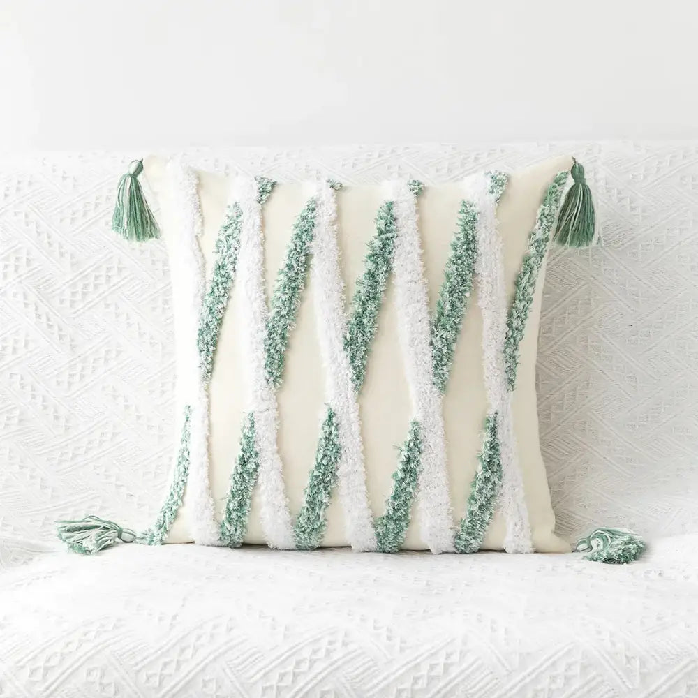 Cream-colored cushion cover with textured green and white vertical stripes and tufted embroidery tassel decorbites geometric tufted design