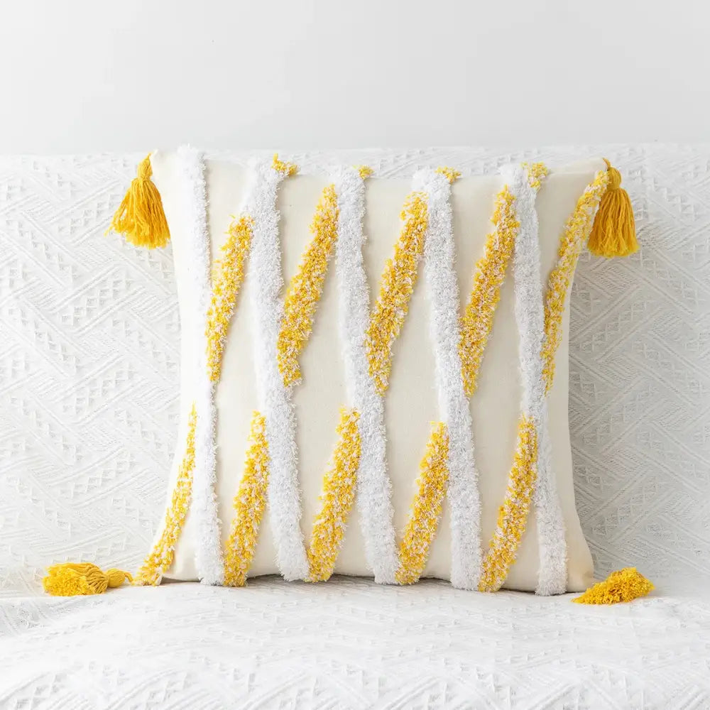Cream-colored cushion cover with bold yellow and white tasselled stripes featuring decorbites geometric tufted embroidery