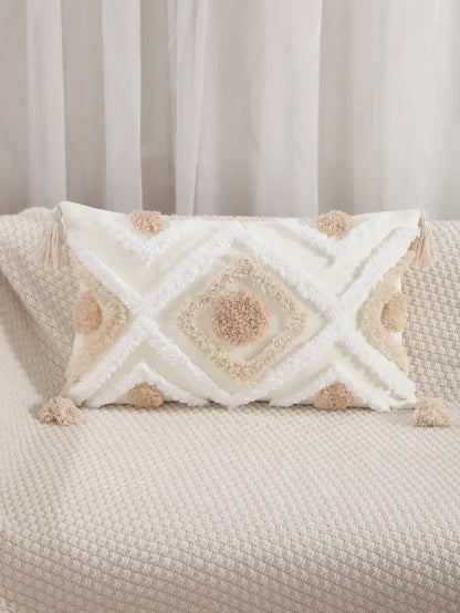 Cream-colored cushion cover with tufted embroidery and beige pom-poms for boho geometric decorbites decor