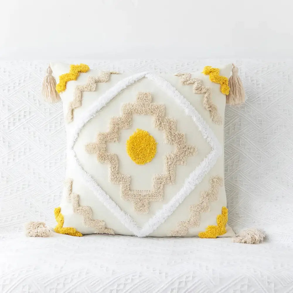 Cream-colored cushion cover with beige and mustard geometric tufted embroidery tassel decor for living room use
