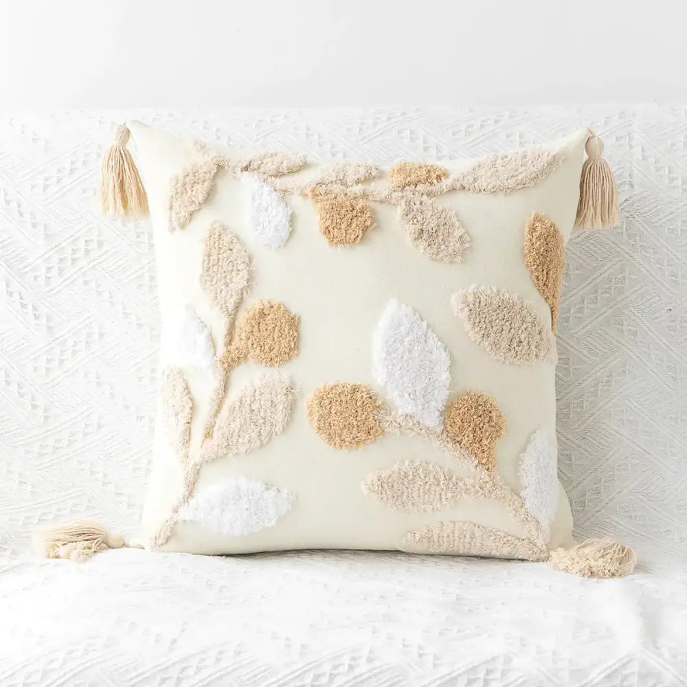 Cream-colored cushion cover with tufted embroidery of leaf and berry motifs and tassels for boho living room decorbites geometric tufted decor