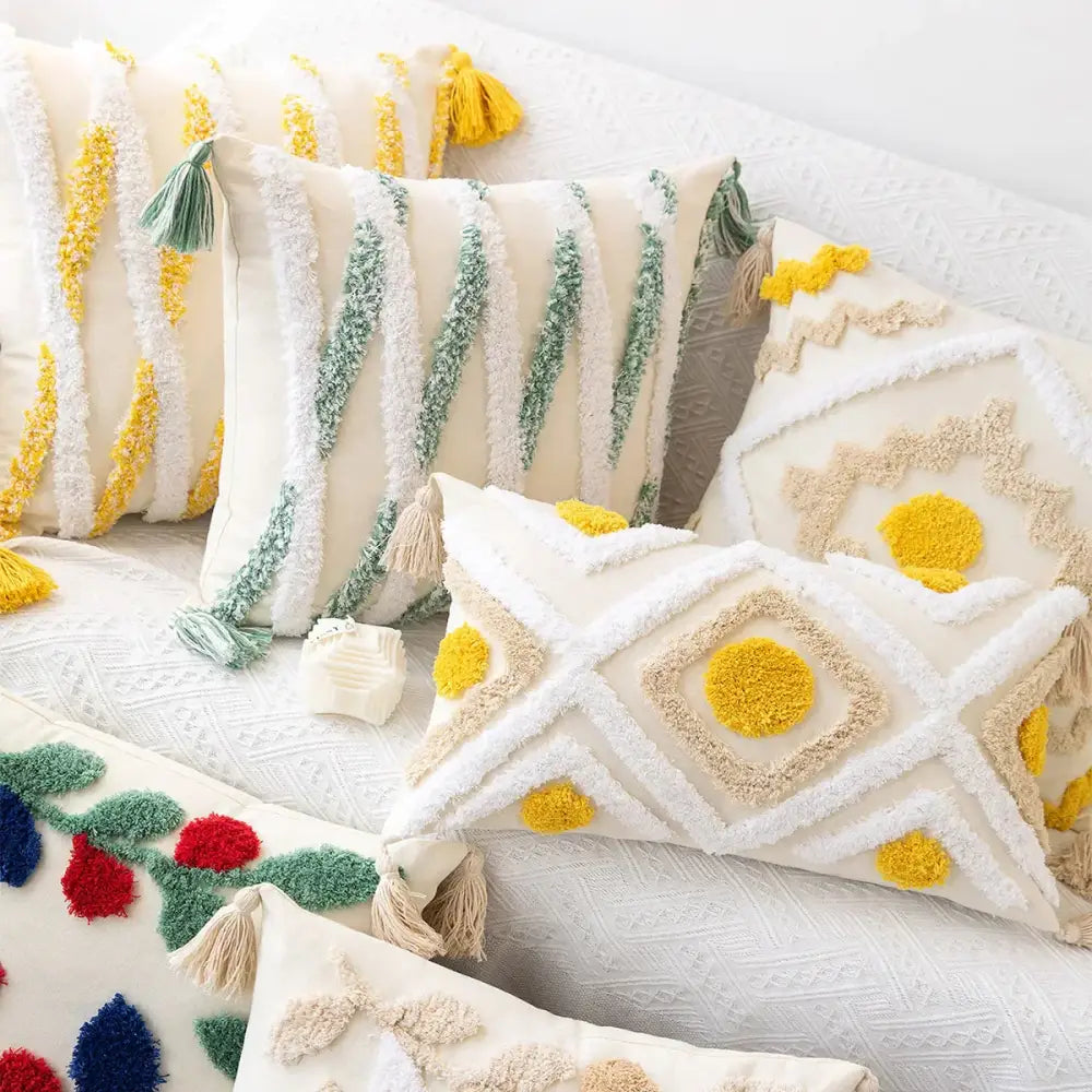 Cream-colored cushion cover with yellow and green tufted embroidery and tassels for boho geometric tufted decorbites decor