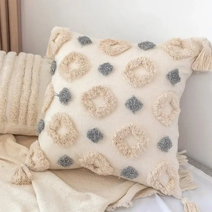 Cream-colored pillow cover with textured beige and gray looped tassels in decorbites geometric tufted design set of 4
