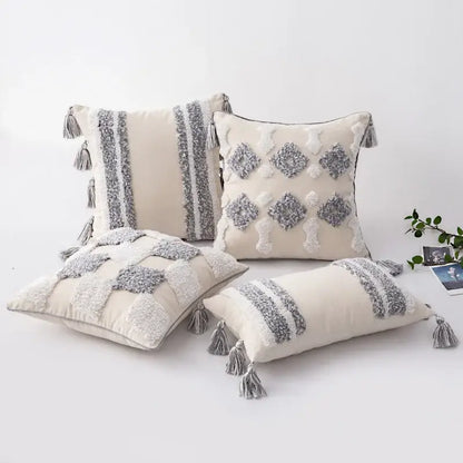 Cream-colored cushion cover with textured gray and white tassel accents for decorbites boho morocco tufted decor