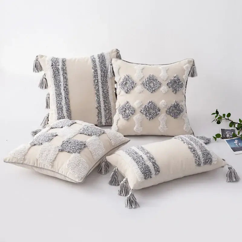 Cream-colored cushion cover with textured gray and white tassel accents for decorbites boho morocco tufted decor