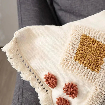 Cream-colored pillow cover with mustard yellow and terracotta crochet details and frayed edges for boho ivory brown decorbites boho ivory