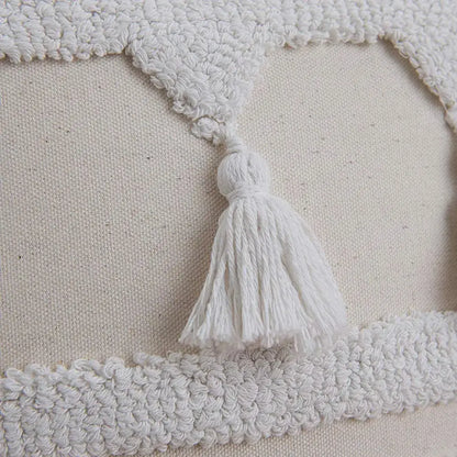Boho ivory tufted tassel cushion cover with white tassel hanging from a textured cream fabric border for living room decor