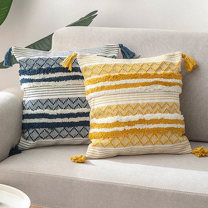 Two textured decorbites boho jacquard cushion covers in navy blue white and mustard yellow cream with tassels