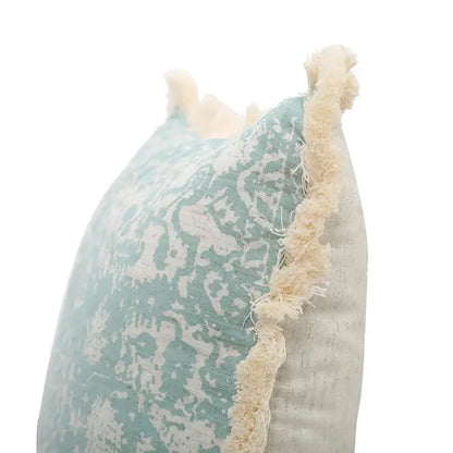 Boho light blue and white patterned pillow cover with teal cream distressed fabric and frayed edge trim decorbites green tassel