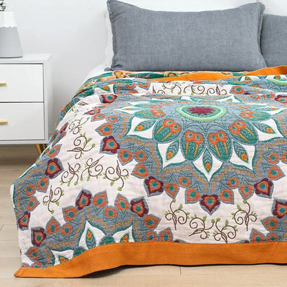 Vibrant boho mandala cotton summer blanket with teal orange embroidery on cream background by decorbites