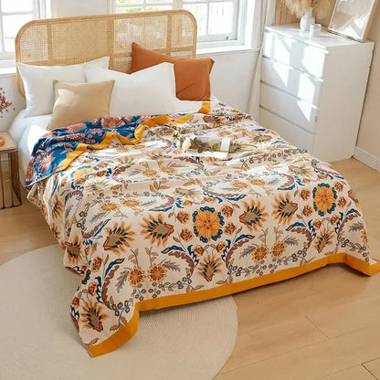 A cozy cream summer blanket with vibrant orange blue floral pattern and mustard-yellow border by decorbites boho mandala cotton