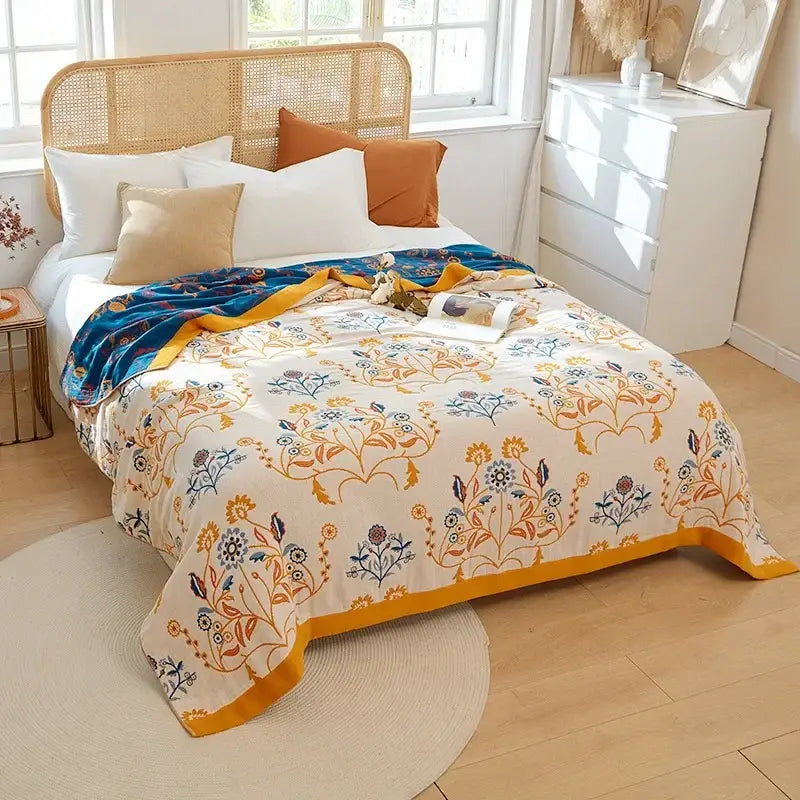 A cozy cream summer blanket with vibrant floral pattern and embroidered mustard yellow border by decorbites boho mandala cotton